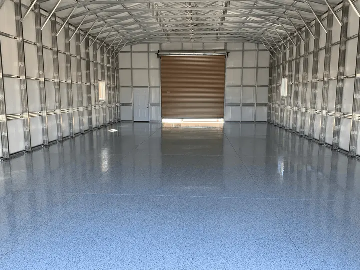 Flake floor inside a steel building with a roll-up door